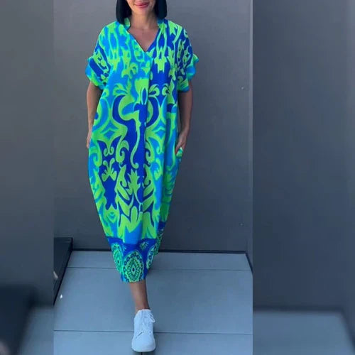 Elena™ | Blommig och elegant klänning med svepande siluett